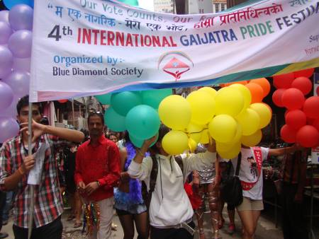 People march holding balloons at Pride Nepal 2013